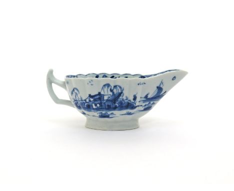 A Worcester blue and white fluted sauceboat, c.1755-60, painted with the Fringed Tree pattern, one side with a figure fishing