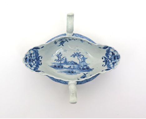 A Worcester blue and white two-handled sauceboat, c.1760, painted with the Two-Handled Sauceboat Landscape pattern, the exter
