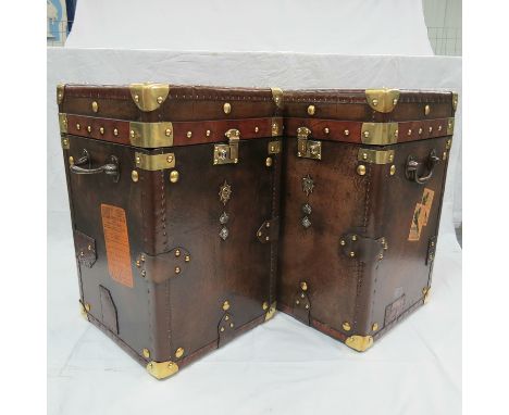 A Pair of Army and Navy Leather covered Trunks