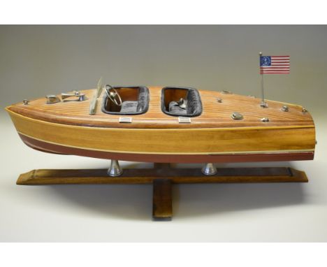 A wooden scale model of a 1950s Riva style speedboat,&nbsp;43cm hull, on wooden stand.&nbsp; 