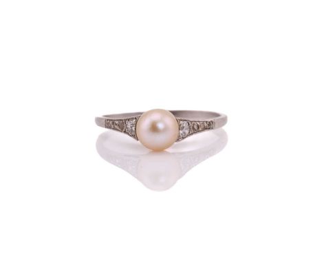 An art deco style pearl and diamond ring, comprises an egg-shaped pearl with a yellow tint approximately measuring 6.2 x 5.7 