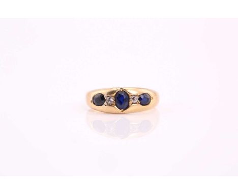 A five stone half hoop sapphire and diamond ring; the oval cut sapphires and old brilliant cut diamonds flush set within a ta