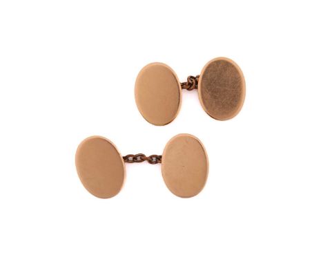 A pair of 15ct gold oval cufflinks, each consisting of plain oval yellow gold panels approximately measuring 1.8 x 1.3 cm, co