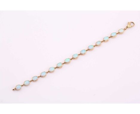 A synthetic opal line bracelet, the fourteen oval cabochons each approximately 8.7mm by 6.6mm, set in yellow metal, 20cm long