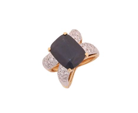 A dress ring with synthetic sapphire and diamonds, comprises an intense coloured cushion-shaped synthetic sapphire measuring 