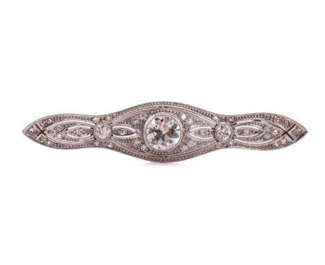 A Belle Époque diamond bar brooch, comprises a transitional-cut diamond of estimated carat weight 1.34ct in the centre, flank