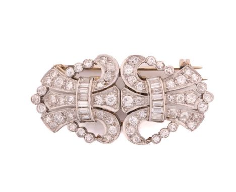 A diamond duette brooch, consisting of two dress clips with fleur-de-lis motif, fully pavéd with round and baguette diamonds,