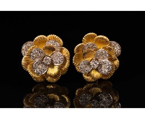 A pair of Kutchinsky platinum and 18ct yellow gold diamond earrings, each comprises a flower head with layering textured peta