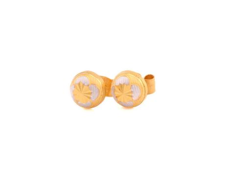 A pair of bi-coloured precious metal ear studs, each consists of a reeded textured dome, centred with a flower motif and brig