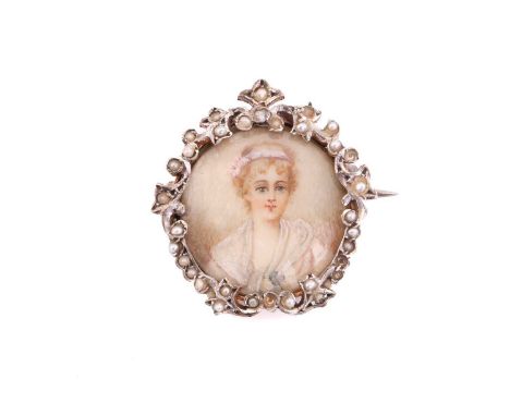 An Edwardian brooch, containing a glazed miniature of a lady, framed with a floral ornated white metal surround set with seed