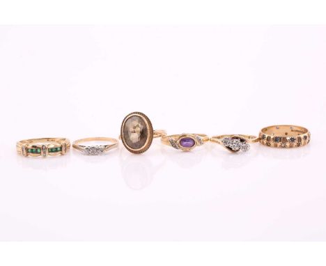 A collection of six rings. A ring with faceted greenstones and diamonds set in a 9ct gold mount, with Sheffield import hallma