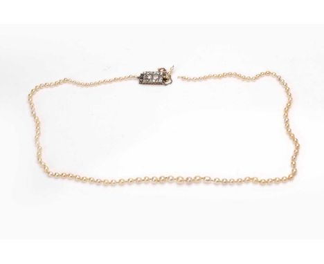 A Victorian string of natural pearls with a diamond-set clasp, consisting of a knotted string of 102 graduating natural pearl