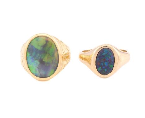 Two opal rings, one comprises an oval precious opal with dark body colour, approximately measuring 17.4 x 12.9 mm, collet set