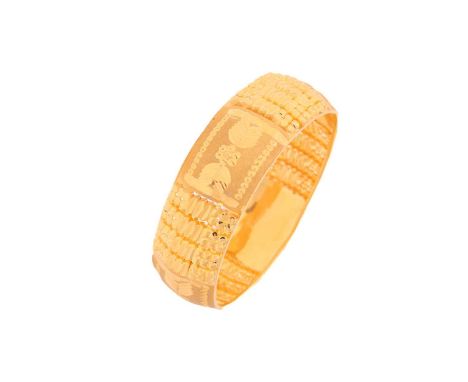 A yellow metal bangle, decorated with pierced, engraved and burred patterns, as well as sandblast finished sections, with inn