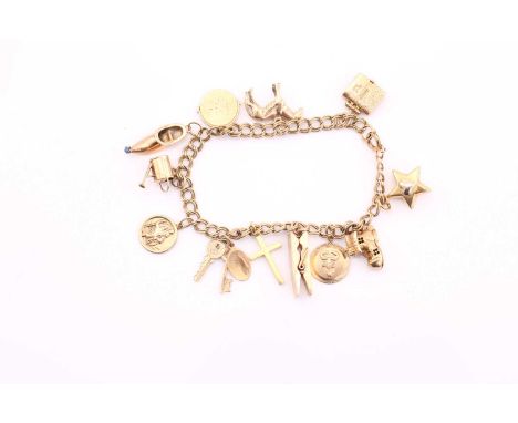 A 9ct gold charm bracelet, consisting of a double curb chain, attached with a collection of 12 assorted gold charms where som