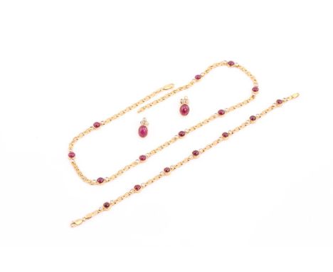 A ruby and diamond necklace, bracelet and earrings en suite; the necklace a composed of nine, three stone cabochon ruby and b