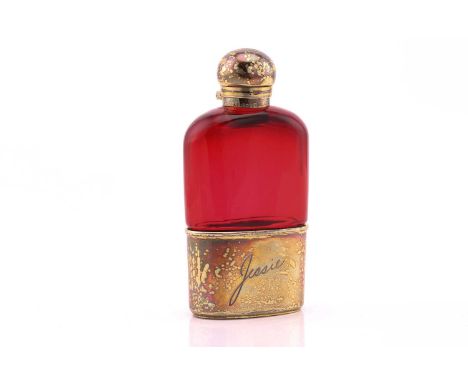 A Victorian silver gilt and ruby flash glass hip flask; pull-off beaker and bayonet cover engraved 'Jessie', in facsimile scr