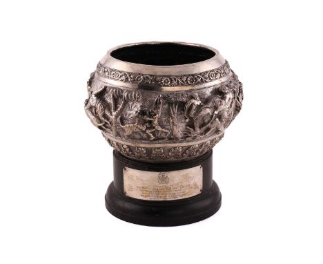 An Indian large white metal commemorative bowl on plinth. The large bulbous bowl profusely chased with bands of acanthus leav