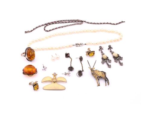 A small collection of jewellery comprising of an amber ring set in white metal stamped 925, an amber brooch set in gilt metal