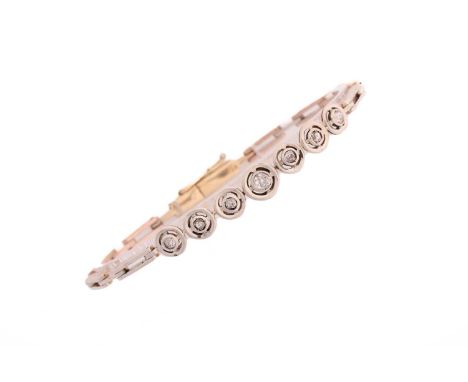 A diamond and bi-coloured precious metal line bracelet, consisting of one larger old-cut diamond, and six smaller diamonds gr