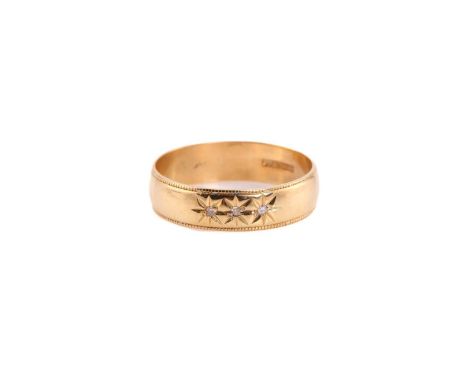 An 18ct gold three stones diamond ring, comprised of three old-cut diamonds, star set on a yellow gold band with a decorative