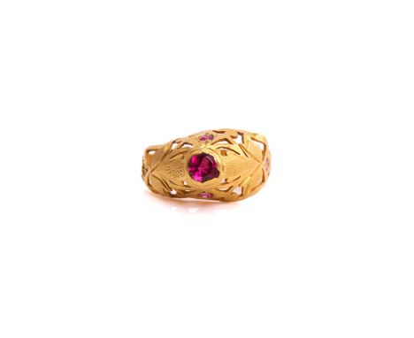 A high carat gold ring with rubies, comprises a bright pink single-cut ruby in the centre approximately measuring 4mm, gypsy 