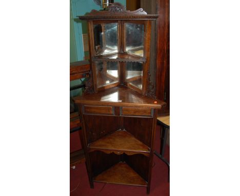 An Edwardian figured walnut and mirrored inset open corner shelf