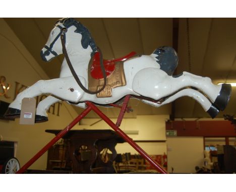 A child's painted metal rocking horse, together with a further child's painted metal toy car, and a Chad Valley spinning top 