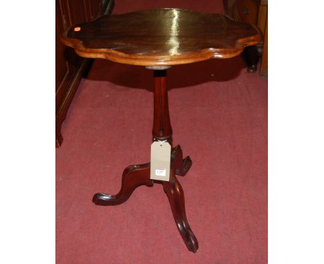 A 19th century mahogany shaped top fixed pedestal tripod occasional table