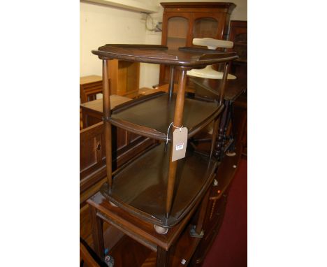 An Ercol dark elm three tier tea trolley on roller castors, width 72cm