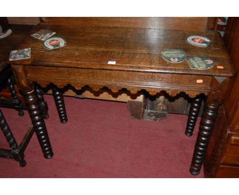 A Victorian oak ledgeback hall table, having single end drawer and raised on bobbin turned supports, w.102cm