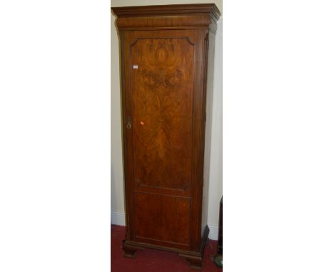 An early 20th century walnut and figured walnut single door hallrobe, on ogee bracket supports, w.67cm