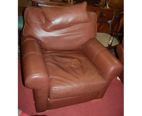 A contemporary Multiyork tan leather three piece suite comprising; three seater sofa and pair of armchairs