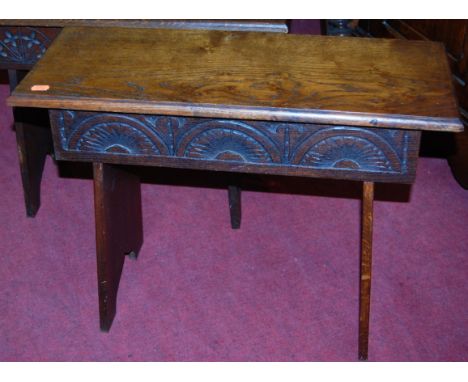 A near pair of relief carved oak bench form stools, width 61.5cm