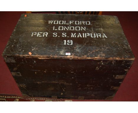 An early 20th century black painted pine and metal bound hinge top military travelling trunk having a galvanised metal lined 