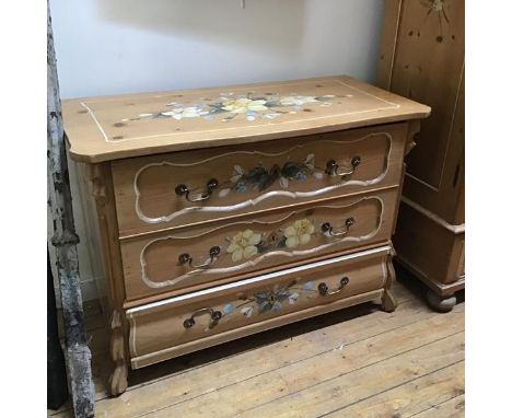 A decorative late 19thc Swiss pine painted commode, the shaped top with handpainted floral sprays above three drawers with ca