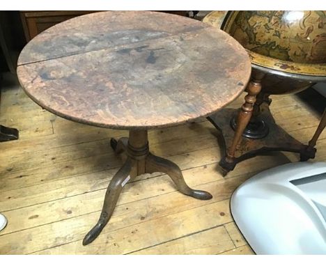 A George III elm snap top occasional table, the circular top with moulded edge (a/f), on turned column and tripod support (h.