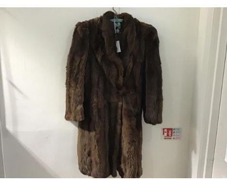 A lady's 1930s vintage three quarter length fur coat with raised collar and single button, with two side pockets, in teddy be