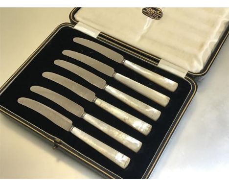 A set of six stainless steel mother of pearl handled side knives