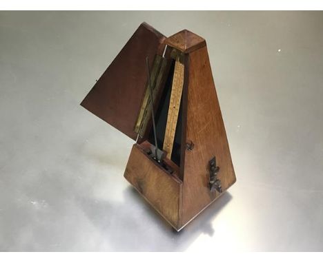 A Maelzel Paquet 1846-1915 walnut cased pyramid shaped metronome raised on bun feet, no. 895,538, complete with weighted pend