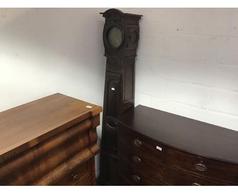 A French 19thc oak longcase clock, the smaller circular brass dial with roman numerals, the hood with arched crest on scrolli