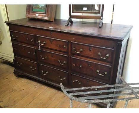 A George III mahogany crossbanded oak mule chest, the hinged rectangular top with moulded edge over an arrangement of dummy d