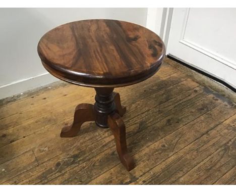 An Eastern hardwood circular top occasional table, the top with moulded edge raised on turned column and carved tripod suppor