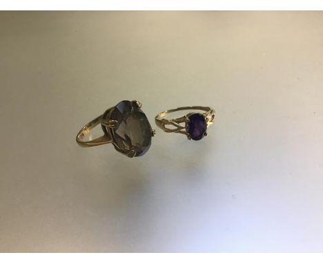 A 9ct gold amethyst set ring (M), and a 9ct gold cairngorm oval mounted ring (L/K) (6.53g) (2)