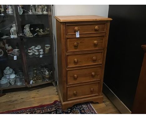Willis Gambier, Bishops Stortford, a stained pine upright tallboy chest, the top with moulded edge above five graduated long 