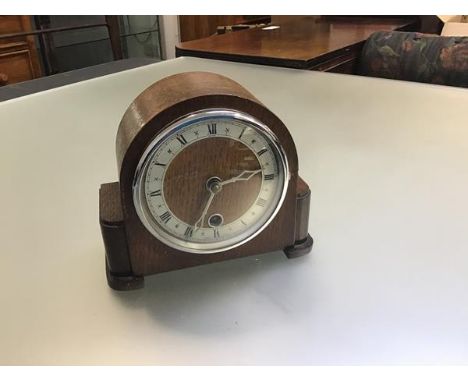 A Davall 1920s oak eight day mantle clock with arched cased and silvered dial with roman numerals and single key aperture, ra