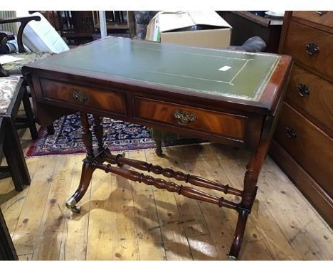 A reproduction mahogany sofa table, the rectangular top with inset green leather gilt tooled skiver, with twin shaped drop fl