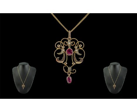 Antique Period 9ct Gold Openwork Ruby Set Pendant attached to a 9ct gold chain, both items marked for 9ct, 22 inches (55cms) 