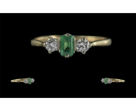 Ladies 18ct Gold Pleasing Quality 3 Stone Diamond and Emerald Set Ring. Marked 18ct to Shank. The Central Step-cut Emerald Fl