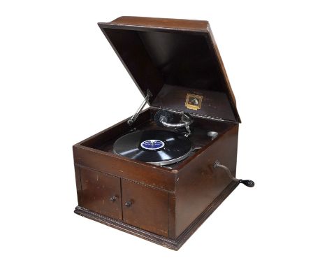 A mahogany cased HMV table top gramophone record player and a small selection of 78 rpm records. Condition - fair to good.